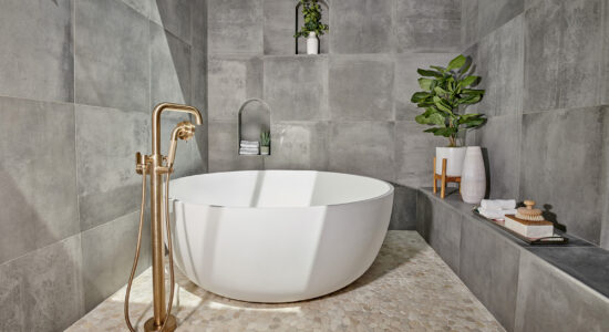 Lewis Bath with natural stone tile and round free standing tub