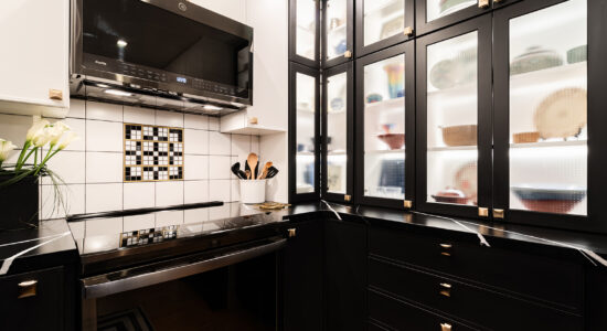 Modern Black & White kitchen with glass door cabinets